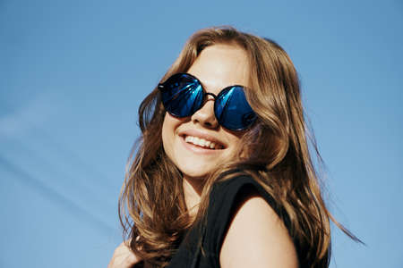 Woman in sunglasses smiling, portrait, street.の写真素材