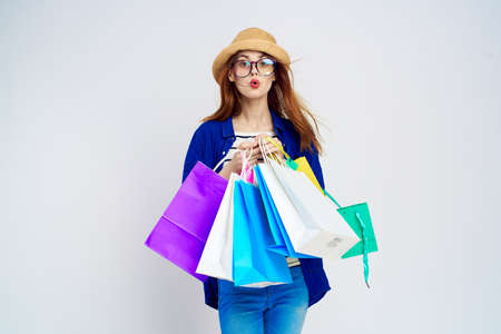 Shopaholic, woman holds many packages, shopping, emotions, gray background, joy.の写真素材