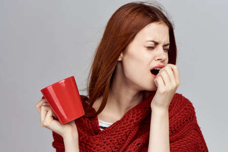 Woman on a gray background sick.の写真素材