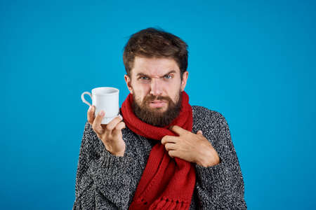 Sick man holds a mug.の写真素材