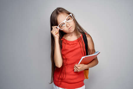 schoolgirl, a girl with glasses is holding a notebook.の写真素材