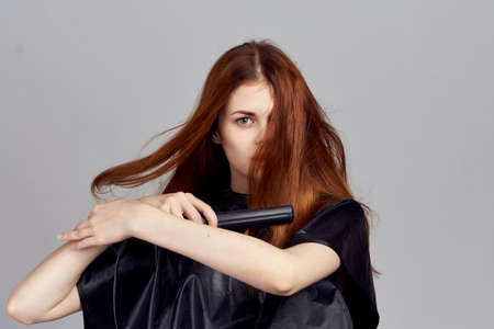 Beautiful woman holding a ployke on a gray background.の写真素材