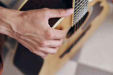man holding a guitar, close-up, musician.の写真素材