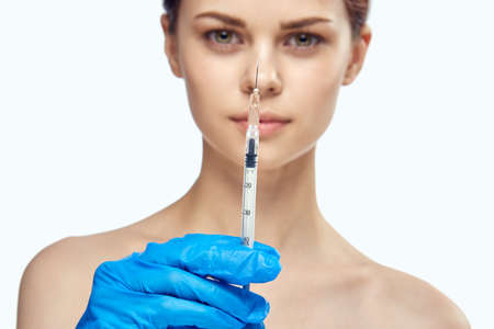woman holding a syringe, portrait, close-up.の写真素材