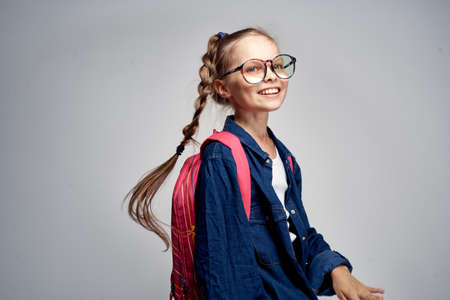 girl in glasses with a backpack, smile.の写真素材