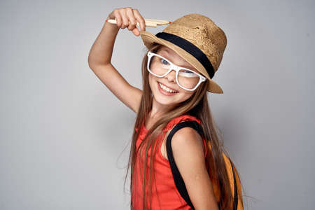 girl in a hat and glasses, smiling, portrait.の写真素材
