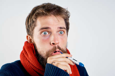 man with a thermometer in his mouth, portrait.