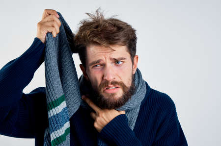 sick man with a beard in a scarf, portrait.の写真素材