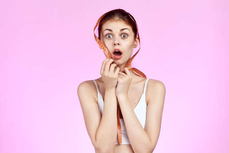 woman on a pink background, emotions, diet.の写真素材