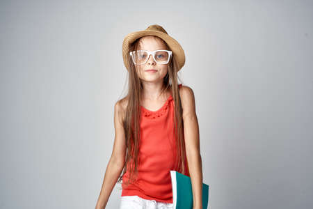 girl with long hair wearing glasses and wearing a hat.の写真素材