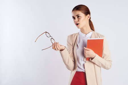 woman teacher holds glasses and says something.の写真素材