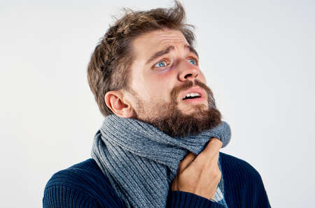 sick man in a scarf, portrait, close-up, emotions.の写真素材