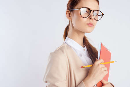 beautiful young with glasses holding notebooks.の写真素材