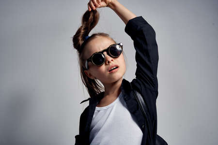 little girl in sunglasses holding her hair, portrait.の写真素材