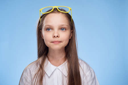 girl with yellow glasses on her head.の写真素材