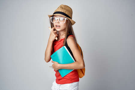 girl in a hat holds stationery.の写真素材