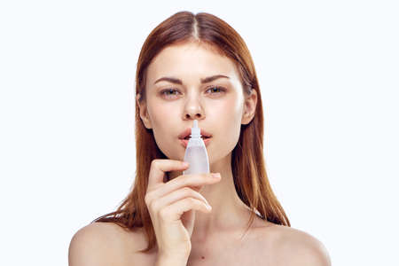 woman keeps drops for eyes and ears.の写真素材