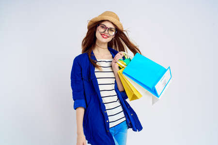 stylish woman with multi-colored packages on a light background, buy, shopping.の写真素材