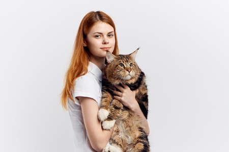 A girl hugs a huge cat.の写真素材