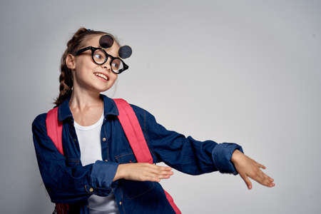 A girl wearing glasses doing dances movesの写真素材