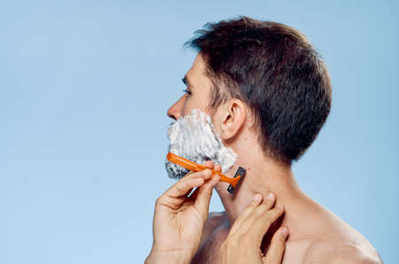 the man in the foam tries to shave.の写真素材