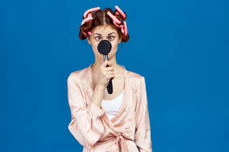 housewife holding a hammer in front of a person on a blue background.