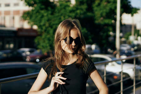 beautiful woman with flying hair walking around the city.