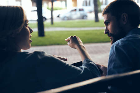 The man and the girl on the bench shot from behind.の写真素材