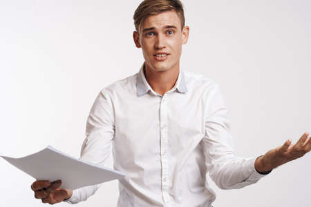 young man in white shirt with paper offers.の写真素材
