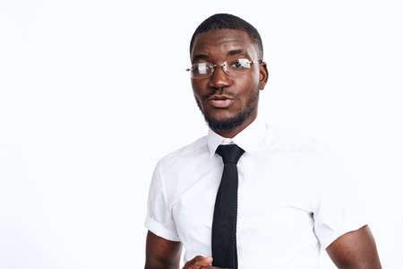 an African in a white shirt and glasses looks interestedの写真素材