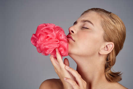 girl with pink bath sponge.の写真素材