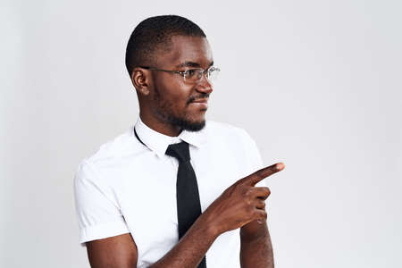 african in white shirt and glasses shows finger directionの写真素材