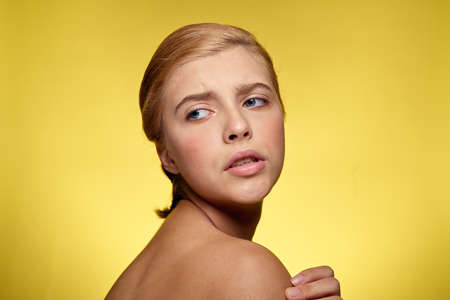 portrait of a girl with a short hairstyle on a yellow background.の写真素材
