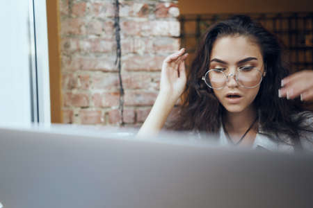 the girl is surprised by what she sees on the laptop.の写真素材