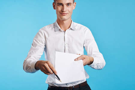 A young guy in a white shirt suggests signing a contract.の写真素材