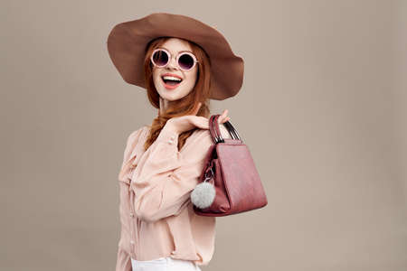 woman with a purse on a light background.の写真素材