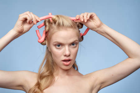 girl with curlers in her hair.の写真素材