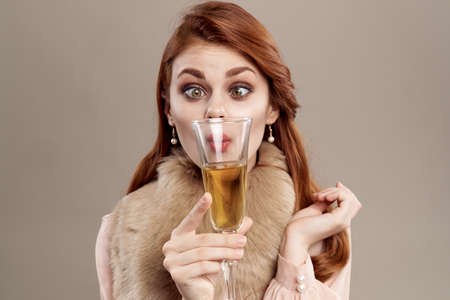 woman with a glass in the foreground.の写真素材