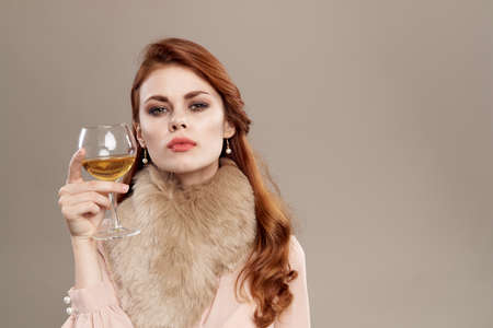 woman with a glass on a light background.の写真素材