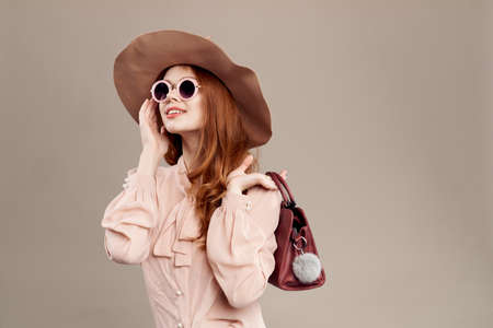 woman with handbag with hand at face.の写真素材