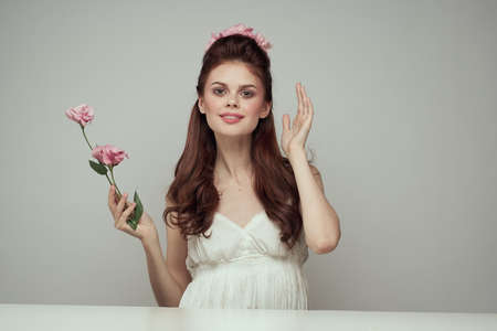 girl with flowers on a light gray background.