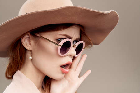 woman with hat and glasses close-up.の写真素材