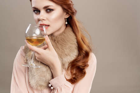 woman with a glass at the mouth.の写真素材