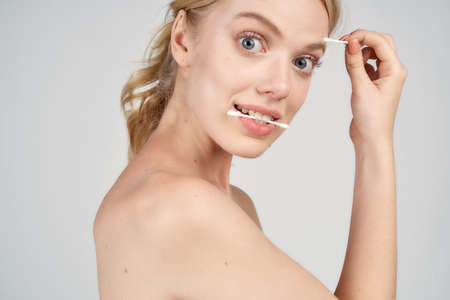 girl holding a cotton swab in her mouth.の写真素材