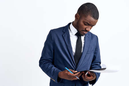 business man holding a pen and paper.の写真素材