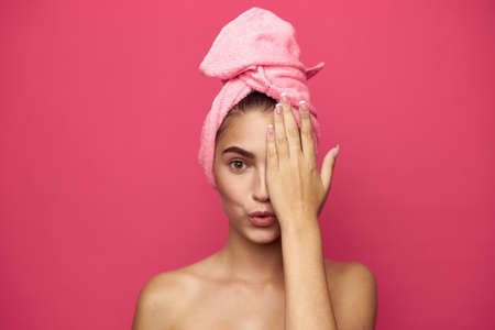 young woman with a towel on her head covers half a person's hand.の写真素材