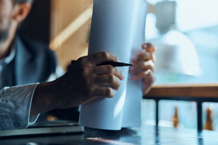 businessman holding a paper and a pen in his hand.の写真素材