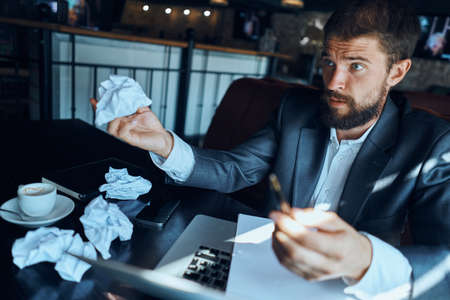 businessman holding a crumpled paper in his hand.の写真素材