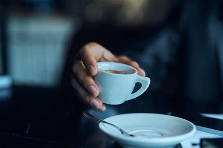 hand, mug, saucer, spoon.の写真素材