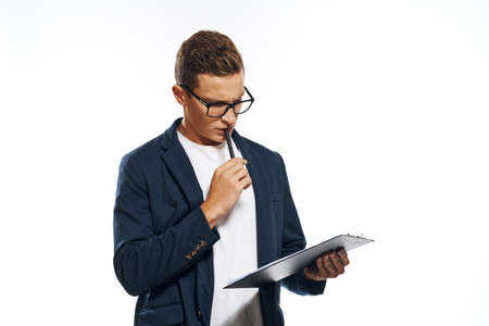 a man in a jacket reflects on notes in a notebook.の写真素材